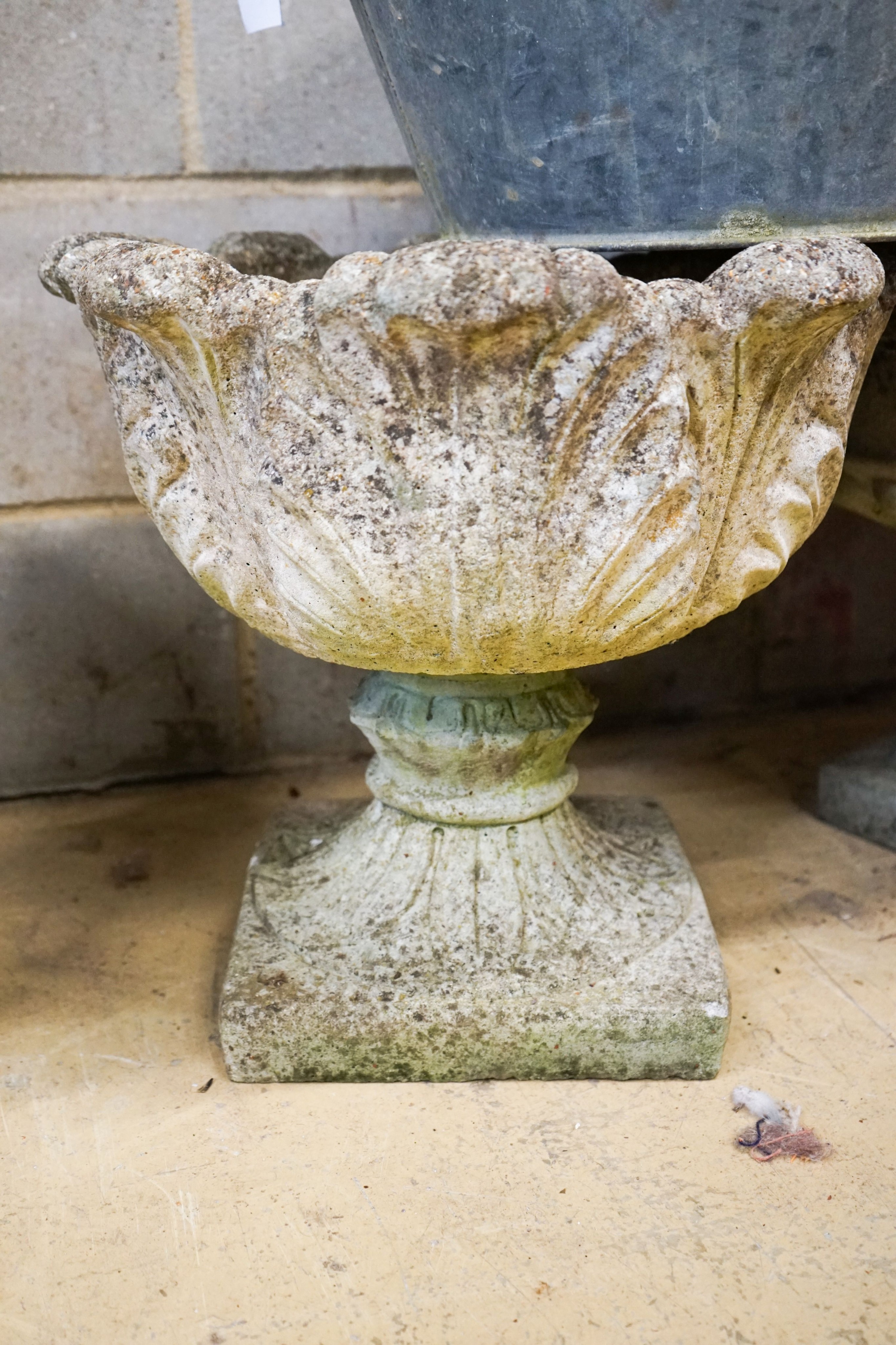 Four assorted reconstituted stone garden urns and a galvanised tub